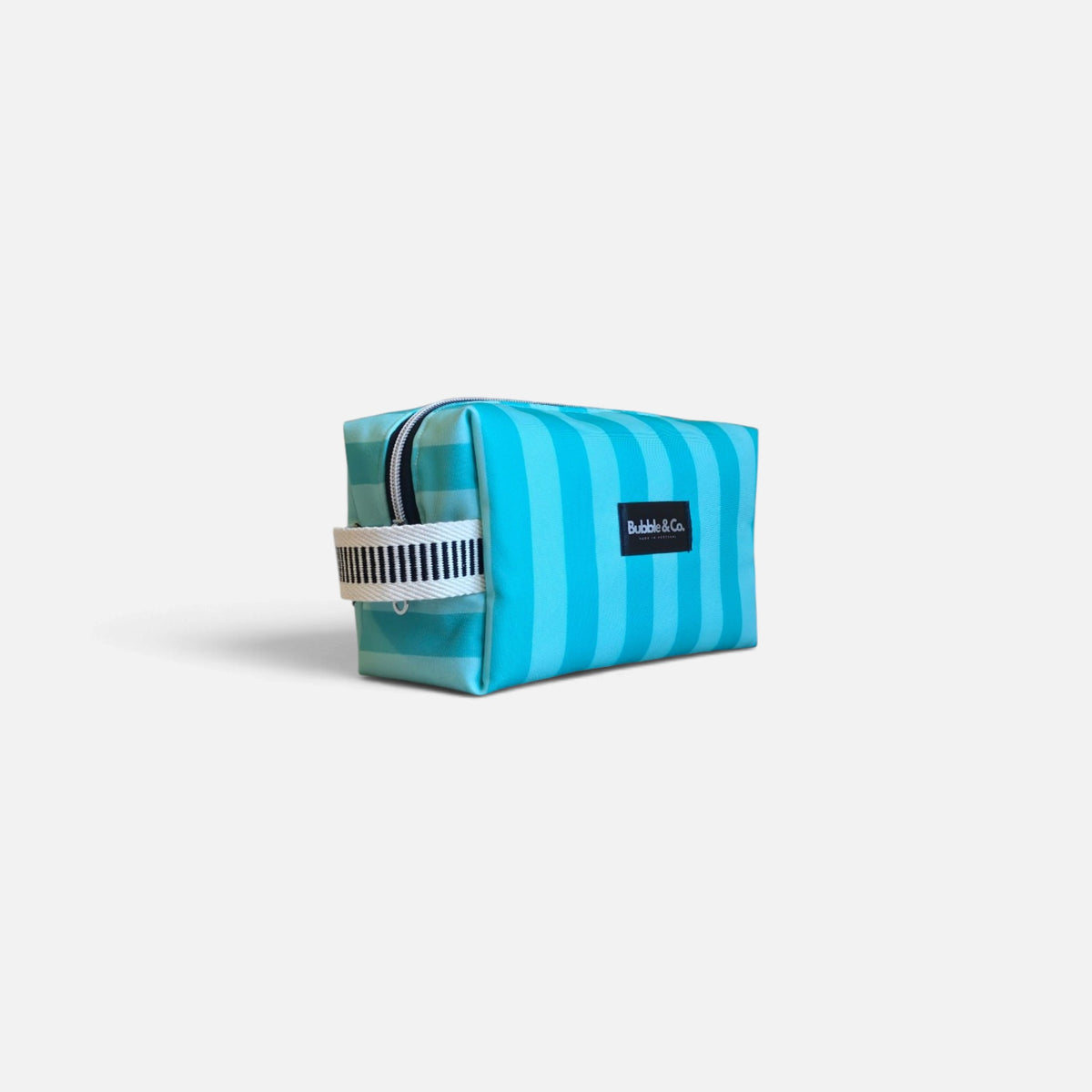 Detail of the Riviera Green large toiletry bag, showcasing its fabric and contemporary design.